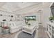Bright living room featuring white furnishings, shiplap accent wall, and a view of the outdoor patio at 2719 River Creek Ln, St Cloud, FL 34771