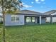The backyard is spacious and green, featuring a covered patio with access via glass sliding doors at 2768 Matera Dr, St Cloud, FL 34771