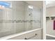Walk-in shower with decorative tiling and glass enclosure adjacent to walk-in closet at 2768 Matera Dr, St Cloud, FL 34771