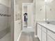 Modern bathroom featuring a glass-enclosed shower and a doorway leading to a walk-in closet at 2768 Matera Dr, St Cloud, FL 34771