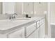 Bathroom vanity with white cabinets, a chrome faucet, and a light countertop at 2768 Matera Dr, St Cloud, FL 34771