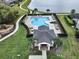 Overhead shot of a community pool, surrounded by lounge chairs, tables, landscaped areas, and a walking path at 2768 Matera Dr, St Cloud, FL 34771