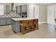 Open concept kitchen with grey cabinets, stainless steel appliances, island with seating and tile floors at 2768 Matera Dr, St Cloud, FL 34771