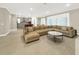 Open-concept living area with tile floors, a large sofa, and seamless flow to the kitchen at 2768 Matera Dr, St Cloud, FL 34771