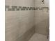Shower with decorative tiling, built-in niche, and chrome showerhead at 2768 Matera Dr, St Cloud, FL 34771