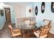 Well-lit dining area adjacent to entryway features neutral colors, wood floors, and an oval glass table at 2800 N Atlantic Ave # 1411, Daytona Beach, FL 32118