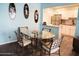 A quaint dining room next to the kitchen features elegant wood floors and light blue walls at 2800 N Atlantic Ave # 1411, Daytona Beach, FL 32118
