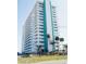 Spacious condo tower featuring multiple balconies with lovely tropical landscaping at 2800 N Atlantic Ave # 1411, Daytona Beach, FL 32118