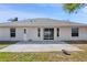 Rear exterior view featuring a patio and sliding glass door, perfect for indoor-outdoor living at 2804 Latter Day Ct, St Cloud, FL 34769