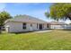 Expansive backyard featuring a patio, grassy lawn, chain link fence, and rear view of the home at 2804 Latter Day Ct, St Cloud, FL 34769