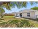Spacious backyard with a grassy area, concrete patio, and view of the home's exterior at 2804 Latter Day Ct, St Cloud, FL 34769