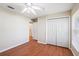 Bright bedroom features a ceiling fan, closet, and wood-look flooring at 2804 Latter Day Ct, St Cloud, FL 34769