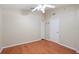 Bright bedroom featuring a ceiling fan, neutral walls, and wood-look floors, offering a serene and comfortable space at 2804 Latter Day Ct, St Cloud, FL 34769