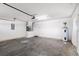 Clean garage with white walls, concrete floor, and a water heater at 2804 Latter Day Ct, St Cloud, FL 34769