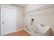 Practical laundry room includes a utility sink and shelving at 2804 Latter Day Ct, St Cloud, FL 34769