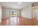 Bright living room featuring a sliding glass door and wood-look flooring, offering a spacious and inviting area at 2804 Latter Day Ct, St Cloud, FL 34769