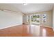 Bright living room featuring a sliding glass door and wood-look flooring, offering a spacious and inviting area at 2804 Latter Day Ct, St Cloud, FL 34769