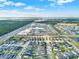 Expansive aerial view of a well-planned community featuring single-Gathering homes, green spaces, and serene ponds at 3005 Crispin Cir, Harmony, FL 34773