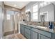 Bathroom featuring double sinks, granite countertops, and a glass-enclosed shower with tiled walls and floor at 3005 Crispin Cir, Harmony, FL 34773