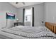 Comfortable bedroom featuring a gray wall, a ceiling fan, and a study area at 3005 Crispin Cir, Harmony, FL 34773