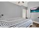 Bright bedroom featuring wood floors, a ceiling fan, and a TV at 3005 Crispin Cir, Harmony, FL 34773