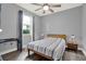 Comfortable bedroom featuring a window, a ceiling fan, and a night stand at 3005 Crispin Cir, Harmony, FL 34773