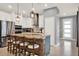 Modern kitchen with white cabinets, stainless steel appliances, a large island, and pendant lighting at 3005 Crispin Cir, Harmony, FL 34773