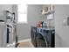 Well-equipped laundry area with gray walls, a window, and ample storage at 3005 Crispin Cir, Harmony, FL 34773