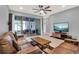 Comfortable living room with a TV, ceiling fan, patio access, and tile floors at 3005 Crispin Cir, Harmony, FL 34773