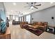 Spacious living room featuring tile floors, ceiling fans, and an open floor plan to the kitchen at 3005 Crispin Cir, Harmony, FL 34773