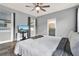 This main bedroom features a ceiling fan, hardwood floors, TV, and ensuite bathroom access at 3005 Crispin Cir, Harmony, FL 34773