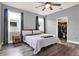 Comfortable main bedroom showcases a ceiling fan, hardwood floors, bright windows and a walk-in closet at 3005 Crispin Cir, Harmony, FL 34773