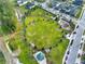 Overhead shot of community park featuring manicured lawn, playground, mature trees, a gazebo, and ample parking at 3005 Crispin Cir, Harmony, FL 34773