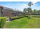 Spacious backyard includes a pool, a pond, tall palm trees and lush green landscaping offering a serene outdoor escape at 304 Acadia Ln, Celebration, FL 34747
