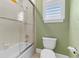 Cozy bathroom featuring a tub-shower combo with glass door and a comfort height toilet at 304 Acadia Ln, Celebration, FL 34747