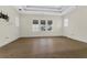Spacious bedroom with wood floors, tray ceilings, and bright windows that let in natural light at 304 Acadia Ln, Celebration, FL 34747
