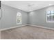 Bright bedroom featuring neutral carpet, a ceiling fan, and windows with stylish white shutters at 304 Acadia Ln, Celebration, FL 34747