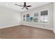Bright bedroom featuring wood floors, ceiling fan, and large windows with plantation shutters at 304 Acadia Ln, Celebration, FL 34747
