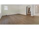 Neutral bedroom with wood floors, light-colored walls, and an entry to a bathroom visible through an archway at 304 Acadia Ln, Celebration, FL 34747