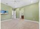 Bedroom featuring green walls, a TV, and bathroom access at 304 Acadia Ln, Celebration, FL 34747