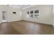 Bright and airy bedroom with wood flooring, white trim, and large windows with plantation shutters at 304 Acadia Ln, Celebration, FL 34747