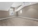 Neutral bedroom featuring large windows and comfortable carpeting at 304 Acadia Ln, Celebration, FL 34747