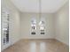 Bright dining room with tile floors, shuttered windows, and sleek pendant lighting at 304 Acadia Ln, Celebration, FL 34747