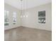 Open dining area with tiled floors, shuttered windows, and modern pendant lighting at 304 Acadia Ln, Celebration, FL 34747