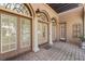 Elegant entrance with arched doorways, stone columns, and decorative lighting, creating a welcoming and grand first impression at 304 Acadia Ln, Celebration, FL 34747