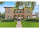 Stunning Mediterranean-style home with a tile roof, arched windows, and a beautifully landscaped front yard with a brick walkway at 304 Acadia Ln, Celebration, FL 34747