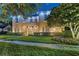 Charming two-story home with a well-manicured lawn and lush landscaping at 304 Acadia Ln, Celebration, FL 34747