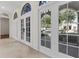 Bright foyer featuring tile flooring, white trim, large arched windows and doors for natural light, creating a grand entrance at 304 Acadia Ln, Celebration, FL 34747