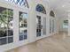 Bright foyer featuring tile flooring, white trim, large arched windows and doors for natural light, creating a grand entrance at 304 Acadia Ln, Celebration, FL 34747