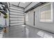 Clean and spacious garage featuring sealed floor, overhead lighting and storage solutions at 304 Acadia Ln, Celebration, FL 34747